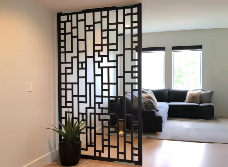 Patterned black aluminium partition design, adding a contemporary touch while offering stylish separation and visual intrigue in the space.