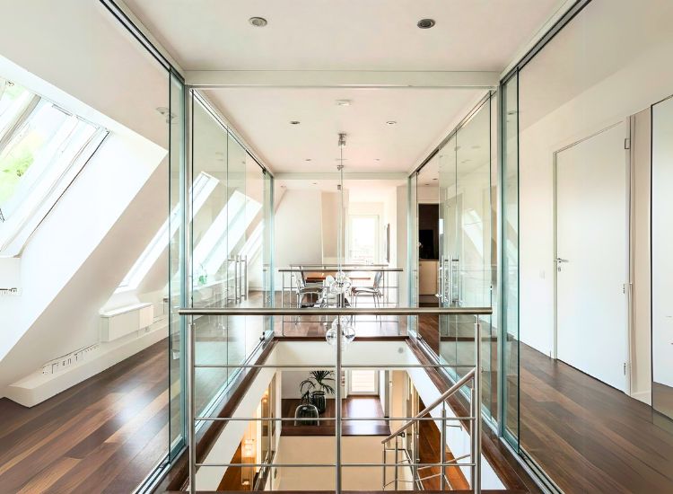 Penthouse design featuring striking glass and metal accents, with sleek glass railings, metallic light fixtures, and contemporary furniture for a modern, stylish touch.