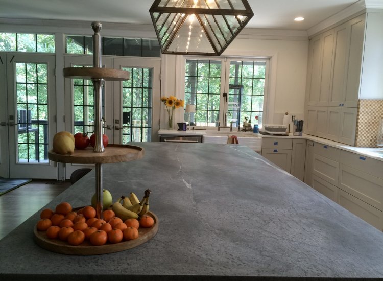 Dark colored soapstone island in a modern kitchen