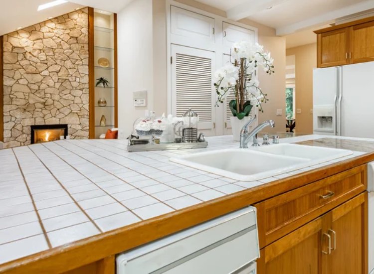 White tile kitchen countertop with sink and tap in beautiful kitchen