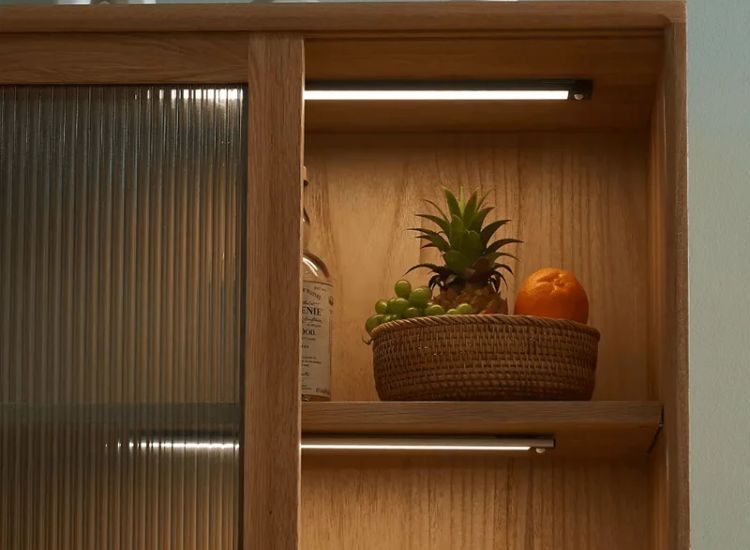 A Wooden Storage Cabinet With Profile Lights Illuminating The Area Adding A Warm And Inviting Ambiance