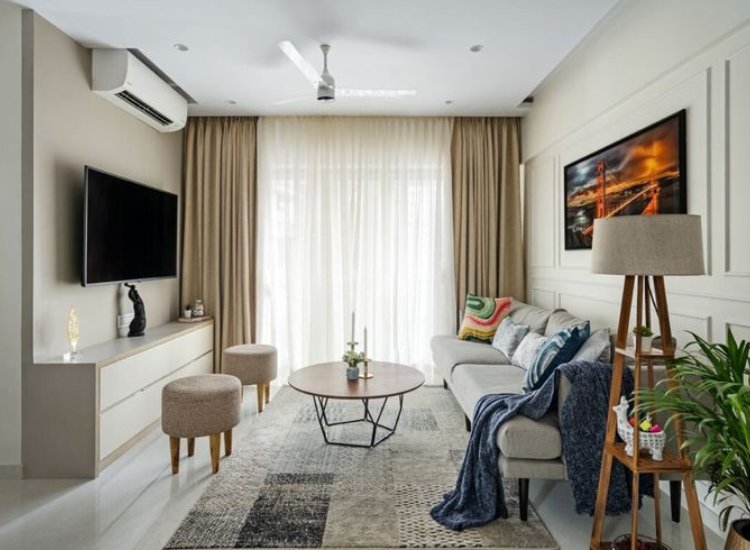 Cozy living room featuring a blend of modern and vintage decor, with plush seating, warm lighting, and vibrant plants.