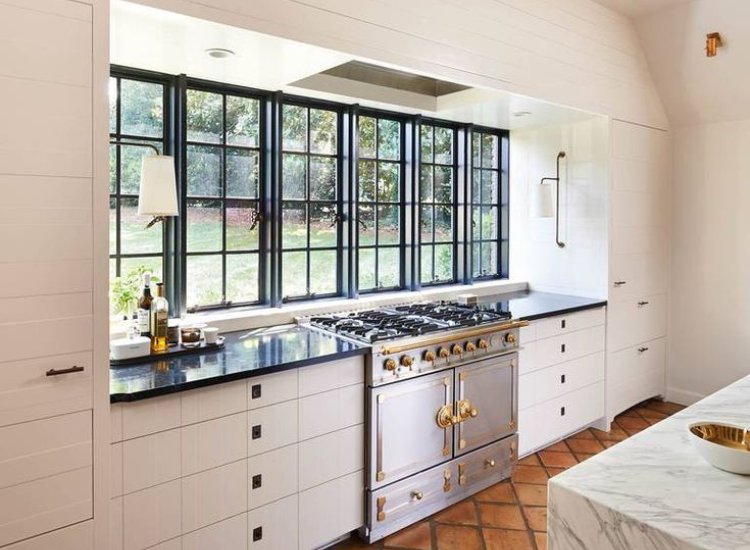 Kitchen ventilation featuring a well-designed windowside countertop, allowing for natural light and airflow while maximizing workspace.