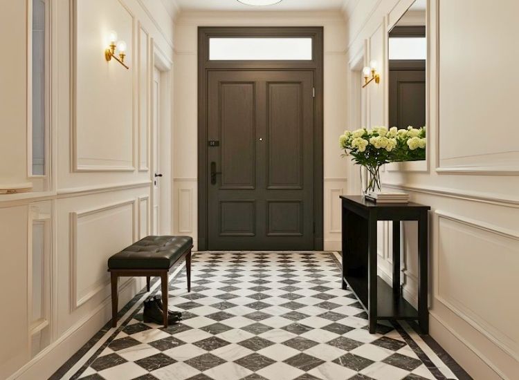 Classic white and black tile flooring adding timeless elegance to foyer entrance design, creating a striking entryway decor.