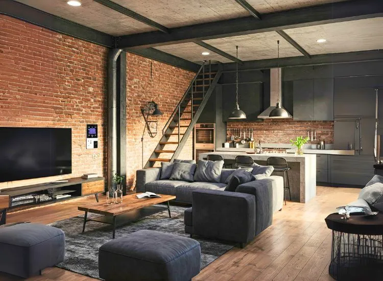 Industrial chic living room design with exposed brick, a grey sofa that’s probably made of concrete, and a lamp that looks like it could power a warehouse.