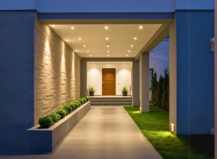 Recessed porch lighting enhances home entrance design, providing subtle illumination and a modern, welcoming ambiance for the entryway.