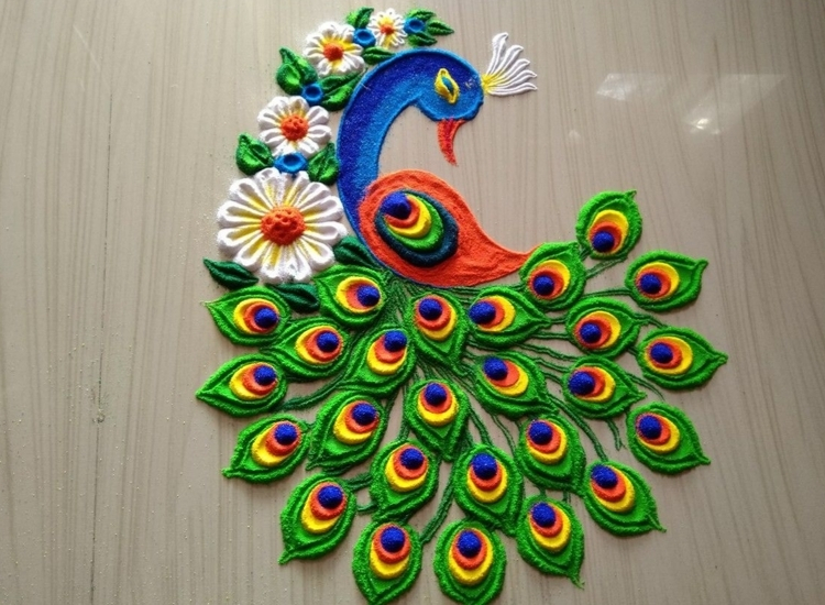 Intricate rangoli design inspired by peacock feathers, showcasing vibrant blues and greens in detailed patterns.