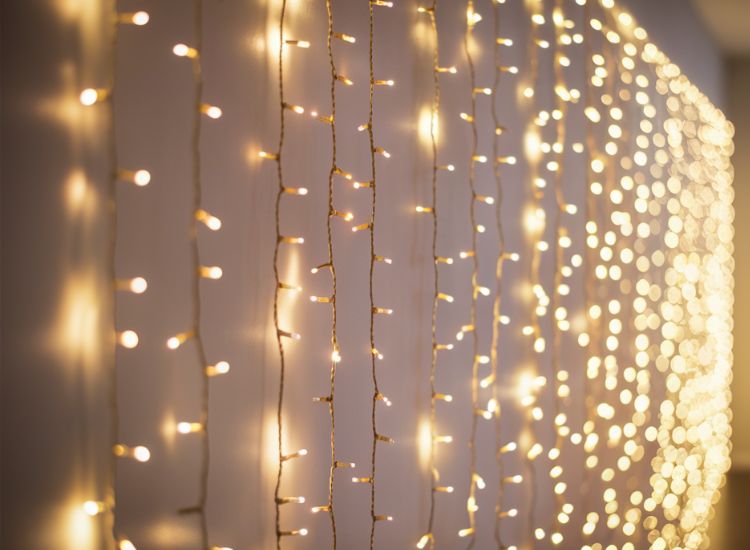Gold and off-white fairy lights hanging on the walls, creating a warm ambiance with a softly blurred background.