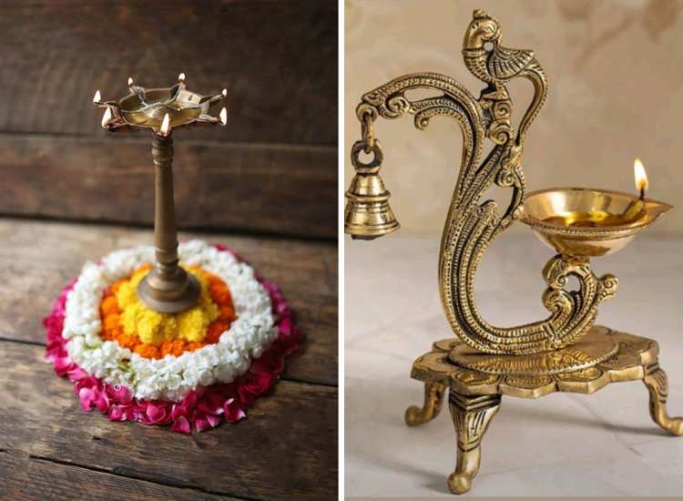 Traditional brass lamps featuring intricate designs, one adorned with rose petals and marigold and lily flowers for a festive touch.
