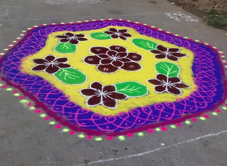 Traditional Muggu rangoli from Andhra Pradesh, featuring intricate geometric designs and vibrant colors, symbolizing prosperity.