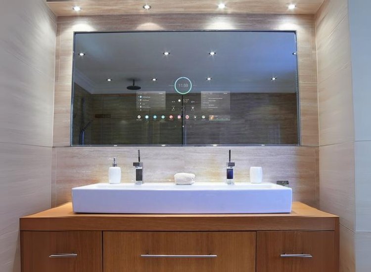 A bathroom featuring integrated technology, magic mirrors, and two sinks for convenience and functionality