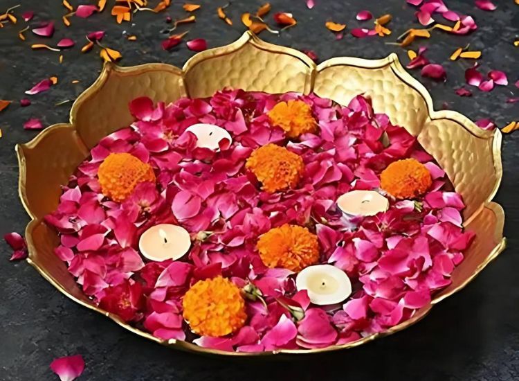 Decorative Urli Design for diwali with rose petals and marigold flowers complemented by small diyas