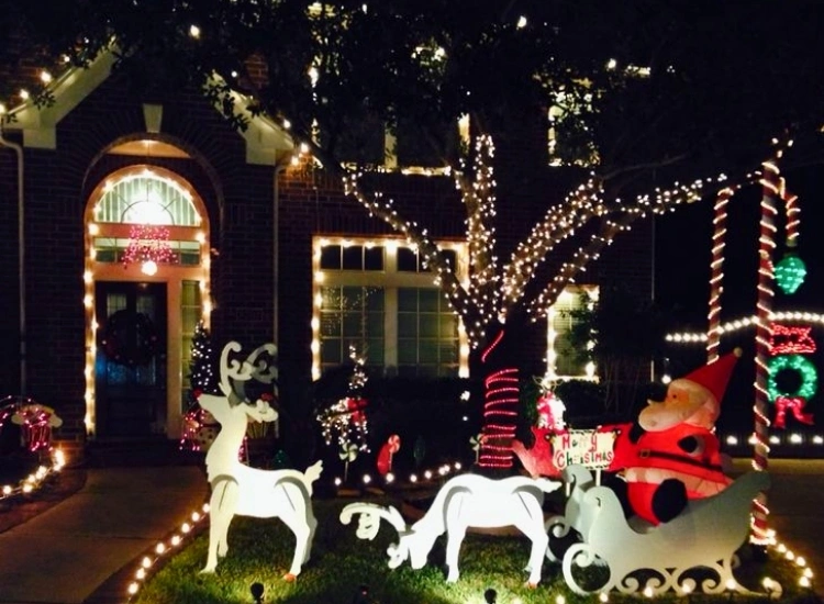 "Illuminated reindeer and Santa figures on the lawn, adding holiday cheer. Christmas tree drawing image included."