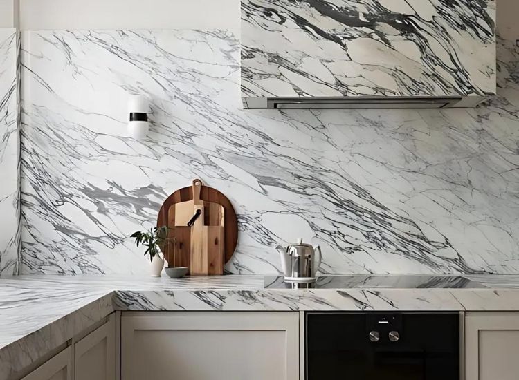 White Calacatta marble with black veins countertop, backsplash and over head cabinet design of the kitchen.