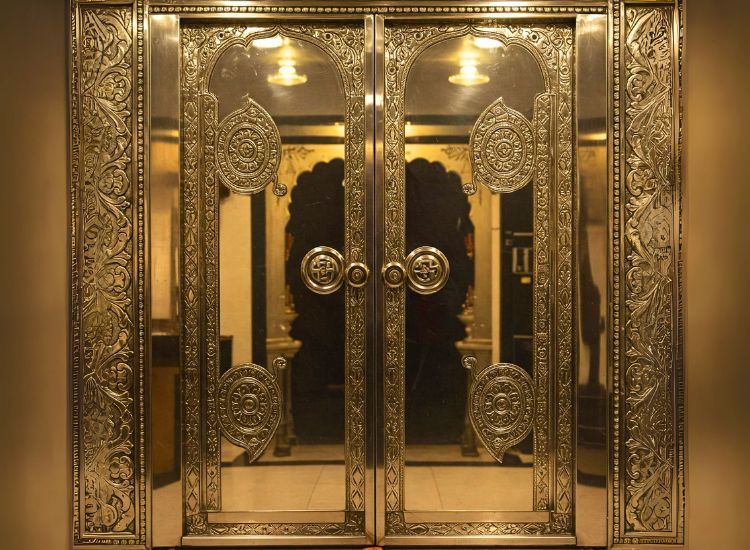 16. Pooja Room Door Design With A Metallic Finish