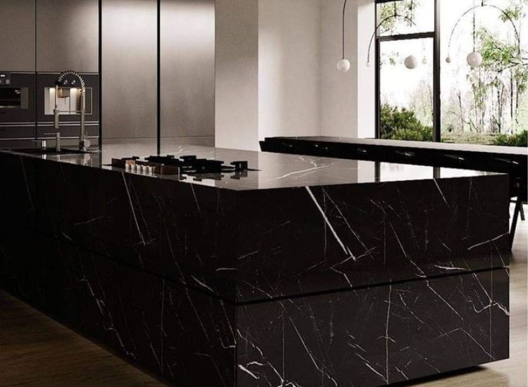 Black marquina marble countertop and island kitchen unit design creating the eye catching effect.