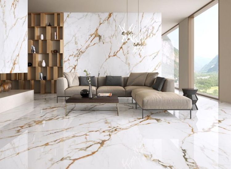White and gold Calacatta marble flooring and wall paneling featuring stylish gold veins in the living room.