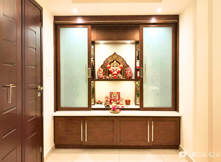 Sliding door mandir unit for your home temple with sleek wooden finish and elegant carvings.
