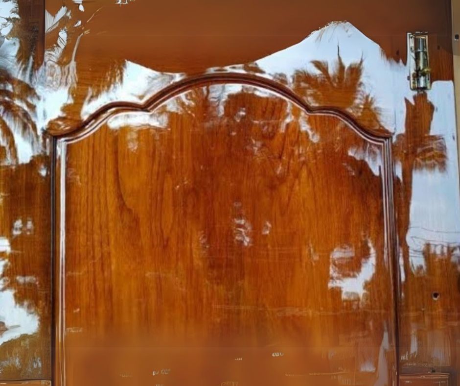 PU polishing on veneer surface featuring glossy finish giving mirror-like reflection on a door