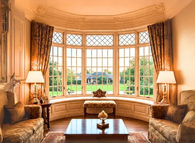 Charming home facade with classic bay and bow windows, offering spacious interiors and timeless home window design ideas.