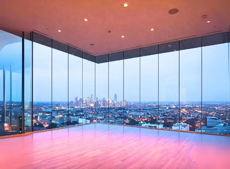 Contemporary living room with floor-to-ceiling glass windows, adding a modern touch and flooding the space with natural light.