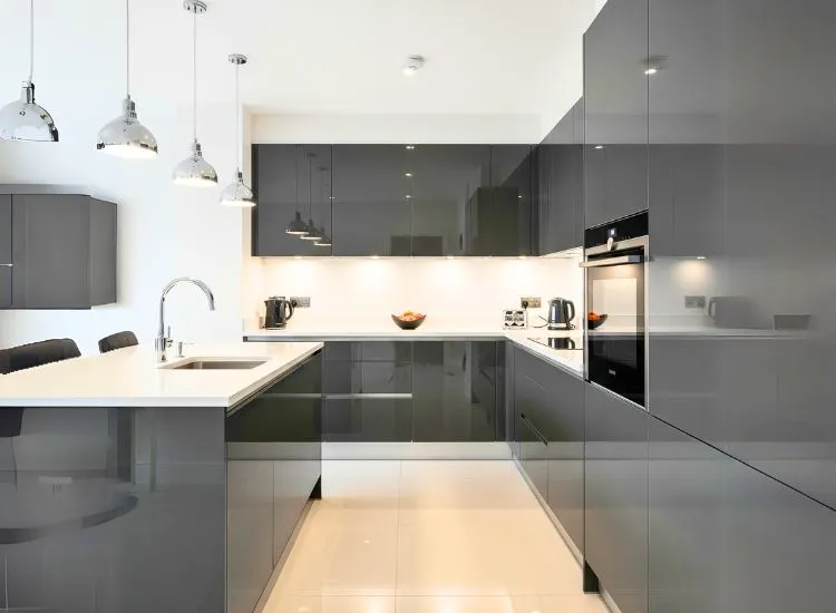 Glossy lacquer modular kitchen cabinets shine with sleek kitchen and cabinet style and polished cupboard designs.